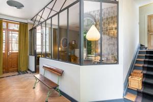 a room with a staircase and a glass wall at Les Gargouilles - House with crazy charm heated pool and garden in Caluire-et-Cuire