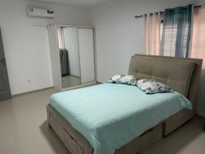 a bed with two pillows in a room with a mirror at Pinto’s in Praia