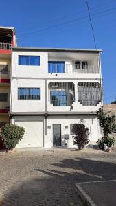 a white building with a lot of windows at Pinto’s in Praia