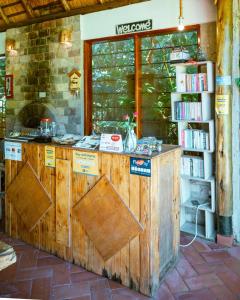 a book store with a wooden counter with two doors at Kisubi Forest Cottages in Entebbe