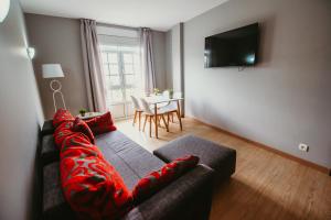 a living room with a couch and a television at LAR DA REVOLTA in Cedeira