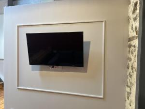 a flat screen tv hanging on a wall at Belle Athenes - Luxury Rooms at Monastiraki Railway Station in Athens