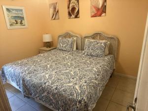 a bedroom with a bed with two pillows at Vibrant Family Condo - Pool & Ocean Panorama #3 in Marathon +30 photos