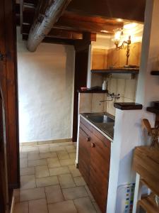 a kitchen with a sink and a counter top at Casa Piccola, Case di Zali in Falmenta +14 photos