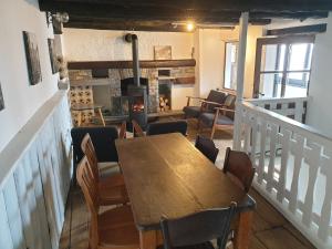 a dining room with a table and chairs and a fireplace at Casa Grande in Falmenta