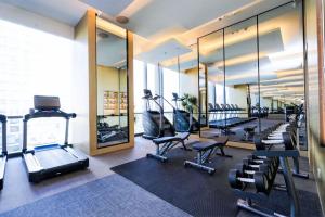 a gym with a row of treadmills and exercise equipment at JW Marriott Hotel Taiyuan in Taiyuan