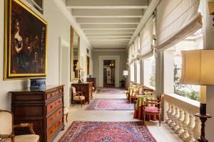 a hallway with chairs and a dresser in a house at The Xara Palace Relais & Chateaux in Mdina