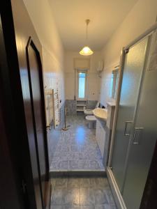 a bathroom with a toilet and a sink at Sweet Home Capodimonte in Naples +23 photos