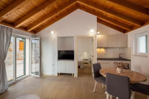 a kitchen and a dining room with a table and chairs at Villa Casa di Perla in Primošten