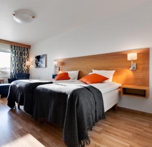 a hotel room with two beds with black blankets at Aurum Hotel in Skellefteå +19 photos