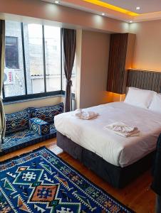a bedroom with a large bed and a large window at Bonita Boutique in Istanbul