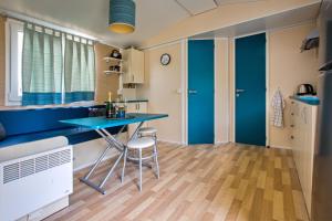 a kitchen with a blue counter and a table at Ubytování VERLIBA in Dvůr Králové nad Labem