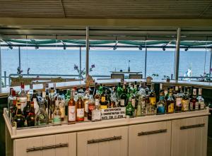 a bar with a lot of bottles of alcohol at Bora Bora Pydna Hotel in Makrygialos