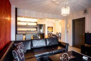 a living room with a leather couch and a table at Villa Miami in Agia Marina Nea Kydonias +52 photos