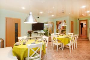 a dining room with a yellow table and chairs at Mini-hotel Sofia in Saint Petersburg