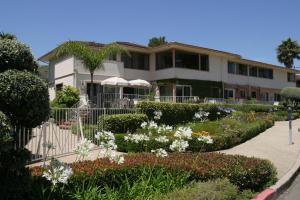 a house with a garden in front of it at Laguna Shores Studio Suites in Laguna Beach