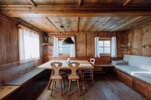 a dining room with a table and chairs at Mountain house Ebner in Selva dei Molini