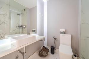 a white bathroom with a sink and a toilet at Norton Matos - T2 in the heart of Braga by House and People in Braga