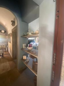a kitchen with wooden shelves in a room at Il Castelletto della Palanzana in Viterbo