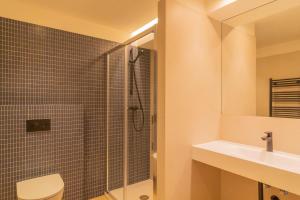 a bathroom with a shower and a toilet and a sink at Apartamento Holidea La Primera del Sardinero in Santander +25 photos