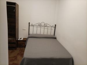 Postel nebo postele na pokoji v ubytování Hostal San Cayetano