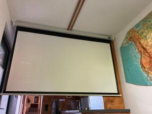 a large projection screen on a wall with a map at Tiny House im Seecontainer mit Parkplatz, Glasfaser, Veranda und gehobener Ausstattung in Coburg