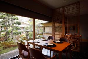 a dining room with a table and chairs and a window at Hotel Nikko Kanazawa in Kanazawa