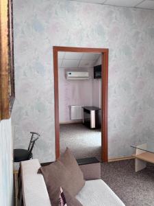 a living room with a mirror and a couch at Hotel Vesta in Brovary