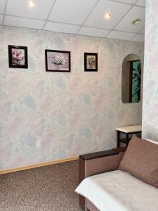 a waiting room with a wall covered in pink roses at Hotel Vesta in Brovary