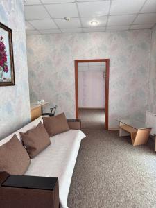 a room with a bed and a wall with flowers at Hotel Vesta in Brovary