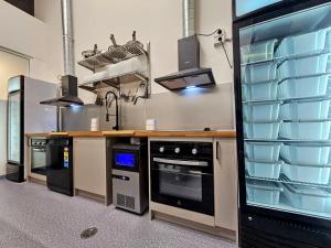 a kitchen with a counter and a stove top oven at Trademark Hostel Sydney in Sydney