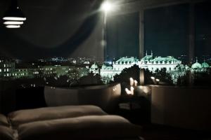 a room with a view of a city at night at Hotel Daniel Vienna - Smart Lifestyle Near City Centre in Vienna