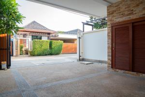 a garage door in a house with a driveway at Near beach 3bedroom pool villa.（Rawai VIP B6） in Rawai Beach