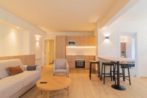 a living room and kitchen with a couch and a table at Apartamento Holidea La Segunda del Sardinero in Santander