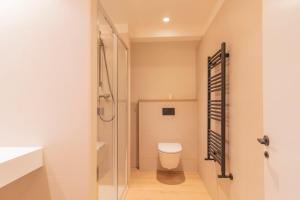 a bathroom with a toilet and a shower at Apartamento Holidea La Segunda del Sardinero in Santander +26 photos