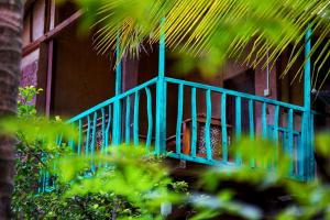 a blue railing on the side of a house at Passion Ray Villa & Tree Hut in Sigiriya