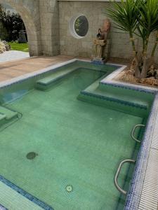 a swimming pool with green water in a house at Resort Terme La Pergola in Casamicciola Terme