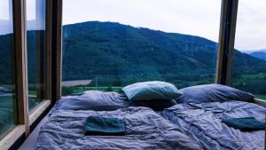 a bed in a room with a view of a mountain at Kajuta in Betliar +26 photos