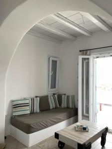 a living room with a couch and a table at MAGGANARI MOMENTS 2 in Manganari