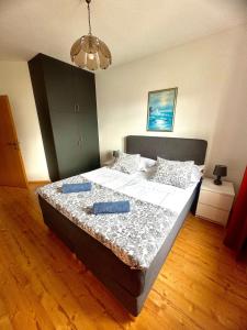 1 dormitorio con 1 cama grande y 2 almohadas azules en Apartments Glavaš, en Makarska