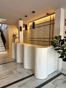 a lobby with a reception desk in a building at Zarú Hotel Boutique in Mocejón
