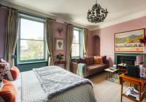 a bedroom with pink walls and a bed and a couch at Hill House in Bath