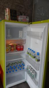 an open refrigerator filled with drinks and water bottles at Lanyu Blue Capsule in Lanyu