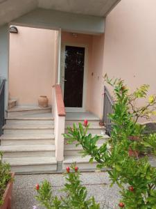 a set of stairs leading to a door of a house at Relax in Maremma in Il Bagno