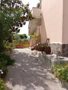 a driveway of a house with a bike parked next to it at Relax in Maremma in Il Bagno