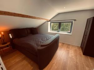 a bedroom with a bed and a window at Scandinavian appartement in Saint-Avold