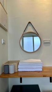 a mirror on top of a wooden table with towels at 山有巷宅 Alley house in Puli