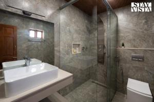 a bathroom with a sink and a shower at 6 BHK Greenwood Bungalow Heritage In the heart of Ooty in Ooty +29 photos
