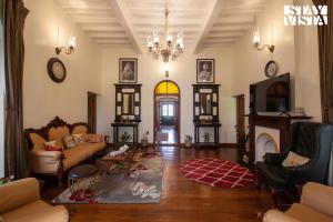 a living room with a couch and a fireplace at StayVista at Greenwood Bungalow - Indoor & Outdoor Game in Ooty