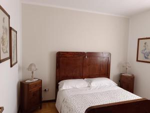 a bedroom with a large bed and two night stands at Morgen in Aquiléia